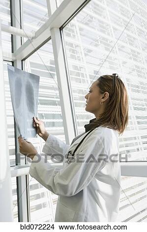 Picture - African doctor reviewing x-ray. Fotosearch
