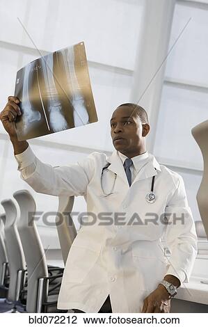 African doctor reviewing x-ray View Large Photo Image Stock Image - African doctor reviewing x-ray. Fotosearch