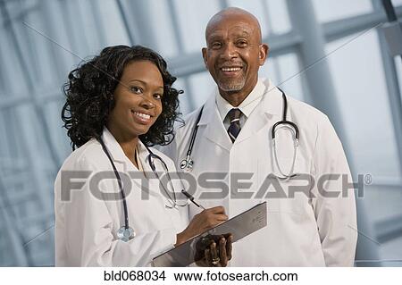 African doctors smiling with medical chart View Large Photo Image Picture - African doctors smiling with medical chart. Fotosearch