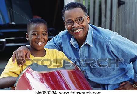Picture - African father and son with go-cart. Fotosearch