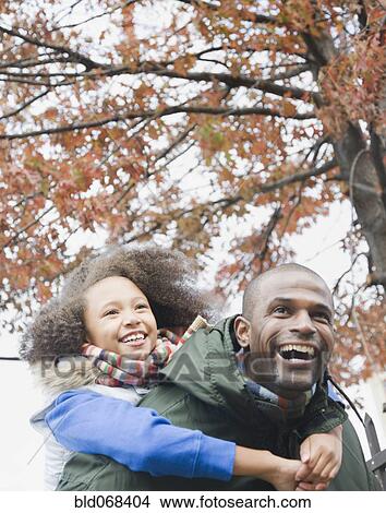 African father carrying daughter piggyback View Large Photo Image Picture - African father carrying daughter piggyback. Fotosearch