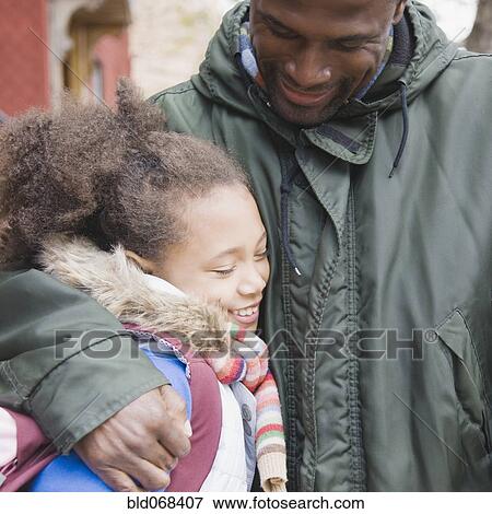 Stock Photo - African father hugging daughter. Fotosearch
