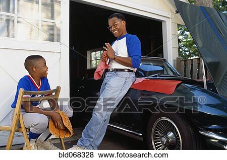 Stock Photo - African father talking with son. Fotosearch