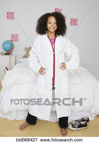 African girl dressed as doctor in bedroom View Large Photo Image Stock Photo - African girl dressed as doctor in bedroom. Fotosearch