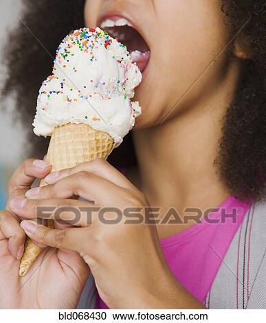 African girl eating ice cream cone View Large Photo Image Stock Image - African girl eating ice cream cone. Fotosearch
