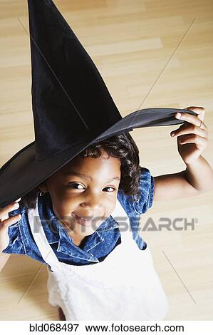 Stock Photo - African girl wearing witch hat. Fotosearch