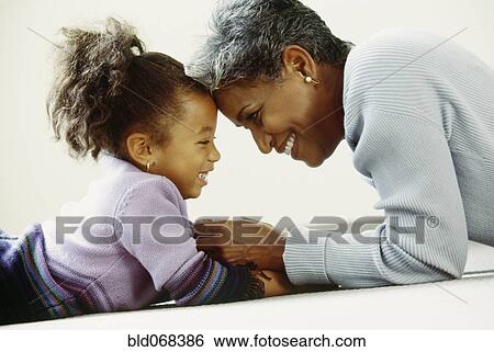 Stock Photograph - African grandmother and granddaughter bonding. Fotosearch