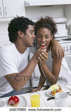African man feeding fruit to girlfriend View Large Photo Image Stock Image - African man feeding fruit to girlfriend. Fotosearch