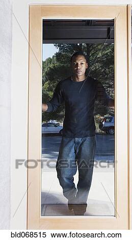 Stock Photography - African man standing in doorway. Fotosearch