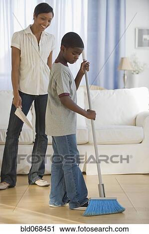African mother and son doing housework together View Large Photo Image Stock Image - African mother and son doing housework together. Fotosearch