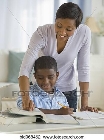 African mother helping son with homework View Large Photo Image Stock Image - African mother helping son with homework. Fotosearch