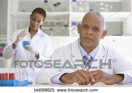 African scientist in laboratory with co-worker in background View Large Photo Image Stock Photography - African scientist in laboratory with co-worker in background. Fotosearch