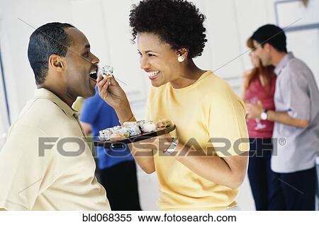 African woman feeding husband sushi View Large Photo Image Stock Photography - African woman feeding husband sushi. Fotosearch