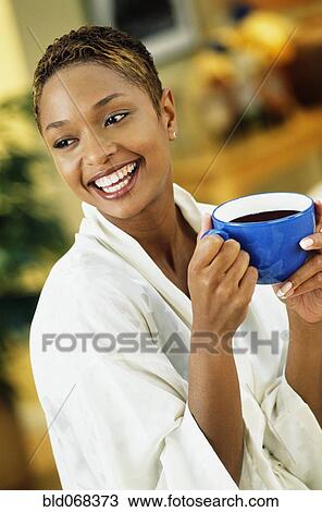 African woman in bathrobe drinking coffee View Large Photo Image Stock Image - African woman in bathrobe drinking coffee. Fotosearch