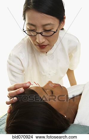 African woman receiving Acupuncture treatment View Large Photo Image Picture - African woman receiving Acupuncture treatment. Fotosearch