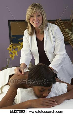 Stock Image - African woman receiving Acupuncture treatment. Fotosearch