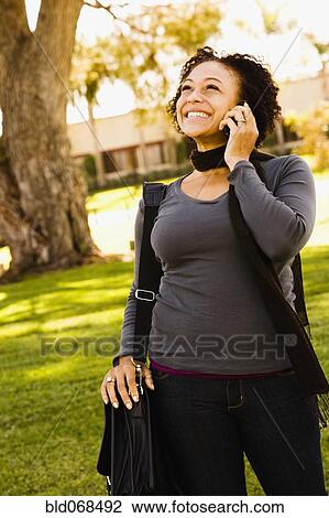African woman talking on cell phone View Large Photo Image Stock Image - African woman talking on cell phone. Fotosearch