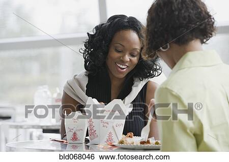 Stock Photograph - African women eating lunch. Fotosearch