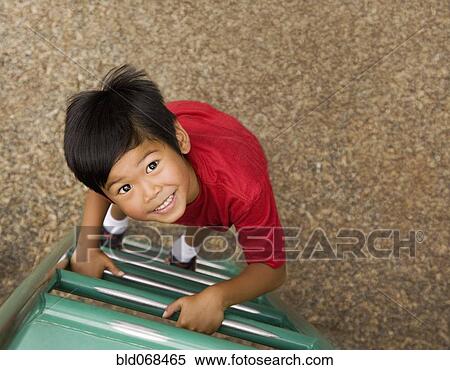 Asian boy climbing ladder on playground View Large Photo Image Stock Photography - Asian boy climbing ladder on playground. Fotosearch
