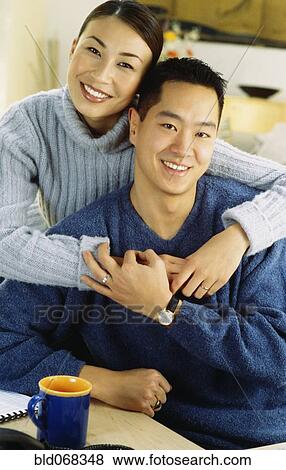 Stock Photo - Asian couple hugging. Fotosearch