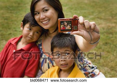 Asian mother and sons taking self-portrait View Large Photo Image Stock Image - Asian mother and sons taking self-portrait. Fotosearch