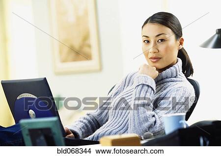 Asian woman using laptop View Large Photo Image Picture - Asian woman using laptop. Fotosearch