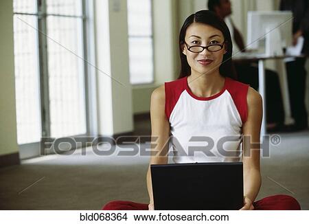 Asian woman using laptop View Large Photo Image Picture - Asian woman using laptop. Fotosearch