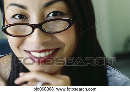 Asian woman wearing eyeglasses View Large Photo Image Stock Photo - Asian woman wearing eyeglasses. Fotosearch