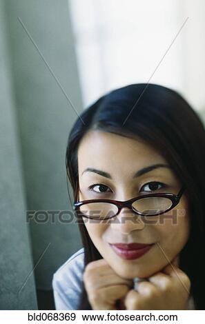 Asian woman wearing eyeglasses View Large Photo Image Stock Photo - Asian woman wearing eyeglasses. Fotosearch