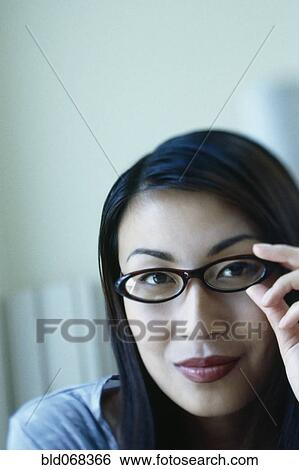 Stock Photograph - Asian woman wearing eyeglasses. Fotosearch
