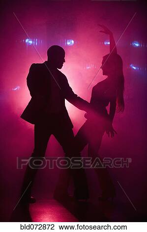 Stock Image - Boyfriend and girlfriend dancing at nightclub. Fotosearch