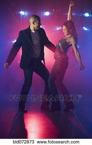 Stock Image - Boyfriend and girlfriend dancing at nightclub. Fotosearch