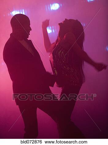 Boyfriend and girlfriend dancing at nightclub View Large Photo Image Stock Photograph - Boyfriend and girlfriend dancing at nightclub. Fotosearch