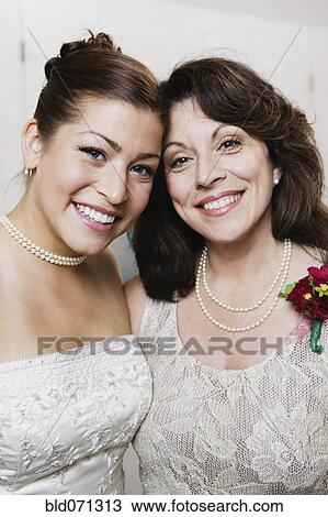 Bride and mother hugging View Large Photo Image Stock Image - Bride and mother hugging. Fotosearch