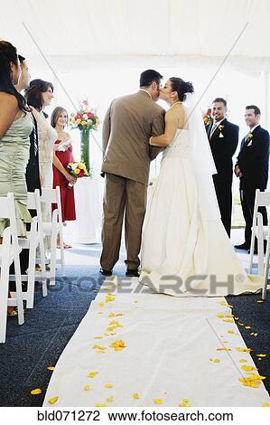 Stock Image - Bride kissing father in aisle. Fotosearch