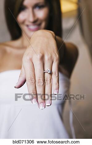 Stock Photograph - Bride showing off ring. Fotosearch