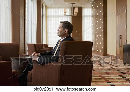 Stock Image - Businessman waiting in lobby. Fotosearch
