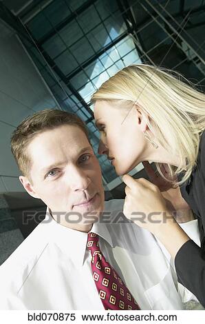 Businesswoman telling businessman a secret View Large Photo Image Stock Photography - Businesswoman telling businessman a secret. Fotosearch