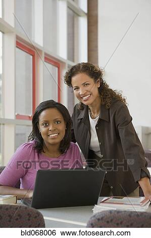 Businesswomen using laptop View Large Photo Image Stock Photograph - Businesswomen using laptop. Fotosearch