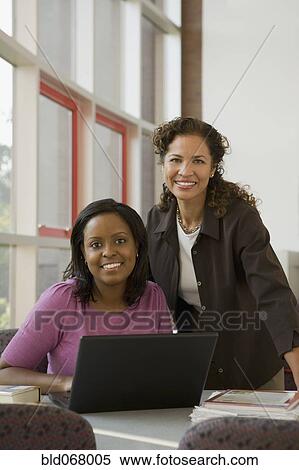 Businesswomen using laptop View Large Photo Image Stock Photography - Businesswomen using laptop. Fotosearch