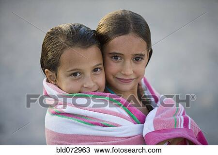 Close up Hispanic girls wrapped in towel together View Large Photo Image Stock Image - Close up Hispanic girls wrapped in towel together. Fotosearch