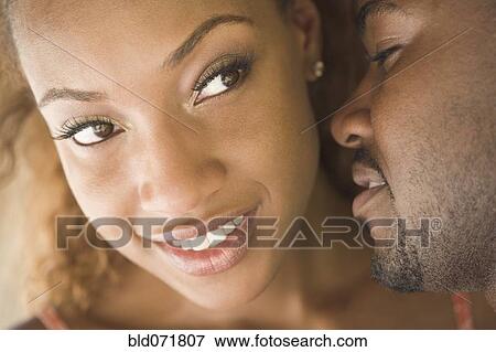 Stock Photo - Close up of African American couple's faces. Fotosearch