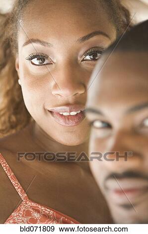 Stock Photo - Close up of African American couple's faces. Fotosearch