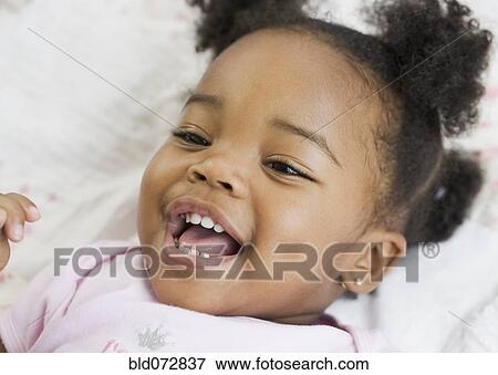 Close up of African American girl laughing View Large Photo Image Stock Photo - Close up of African American girl laughing. Fotosearch