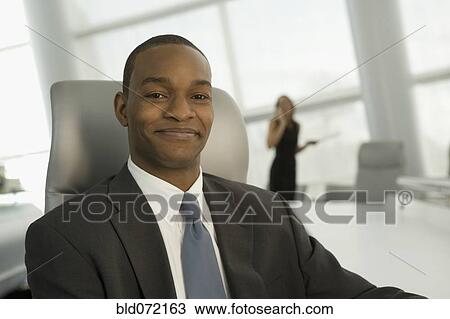Close up of African businessman in conference room smiling View Large Photo Image Stock Image - Close up of African businessman in conference room smiling. Fotosearch