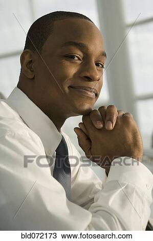 Close up of African businessman with hands clasped View Large Photo Image Stock Image - Close up of African businessman with hands clasped. Fotosearch