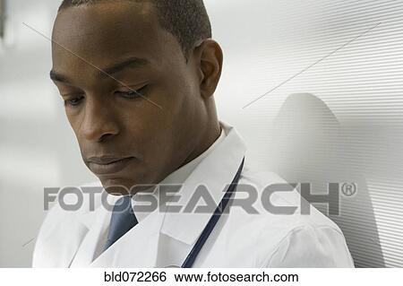 Close up of African doctor looking down View Large Photo Image Stock Photograph - Close up of African doctor looking down. Fotosearch