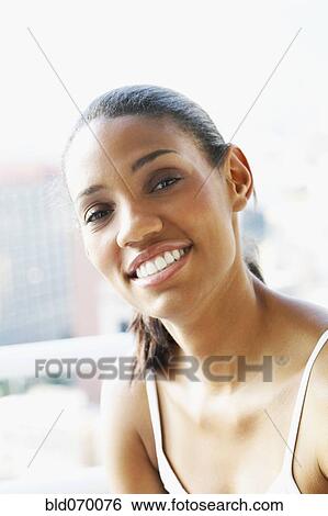 Stock Photograph - Close up of African woman smiling. Fotosearch