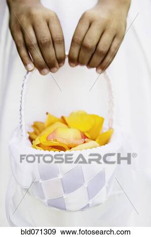 Stock Photo - Close up of flower girl's basket. Fotosearch