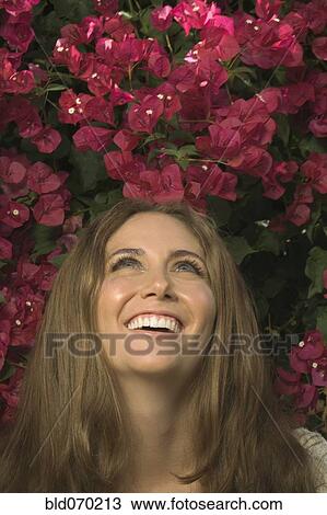 Close up of Hispanic woman looking up at flowers View Large Photo Image Stock Image - Close up of Hispanic woman looking up at flowers. Fotosearch